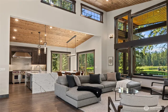 a living room with furniture and large windows