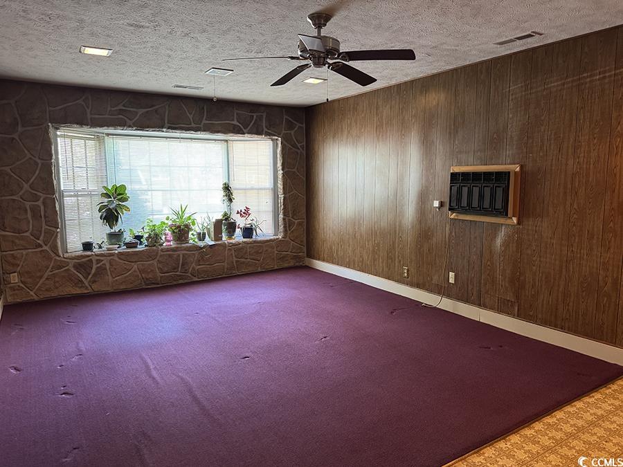 4041 Long Line Lane Myrtle Beach, SC 29579 - Photo 20 of 20 Carpeted spare room with wooden walls, a textured