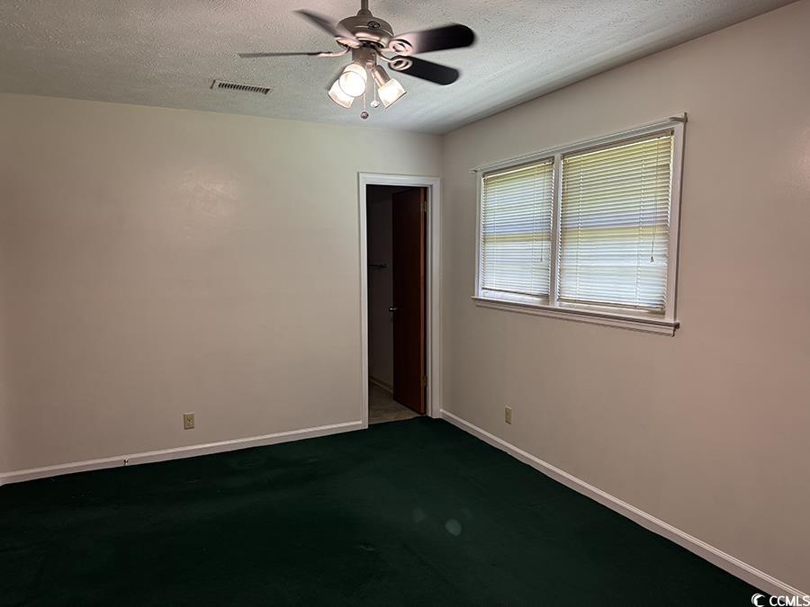 4041 Long Line Lane Myrtle Beach, SC 29579 - Photo 7 of 20 Primary Bedroom with ceiling fan, a textured ceili