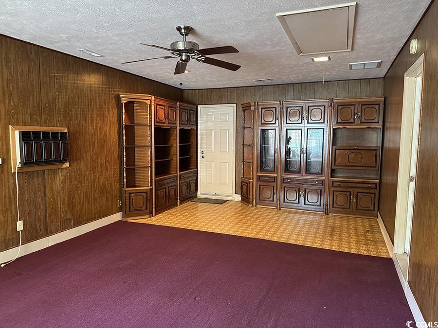 4041 Long Line Lane Myrtle Beach, SC 29579 - Photo 10 of 20 Empty room featuring wooden walls, a ceiling fan,