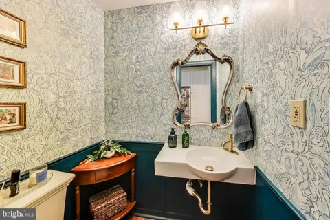 a bathroom with a sink a toilet and mirror