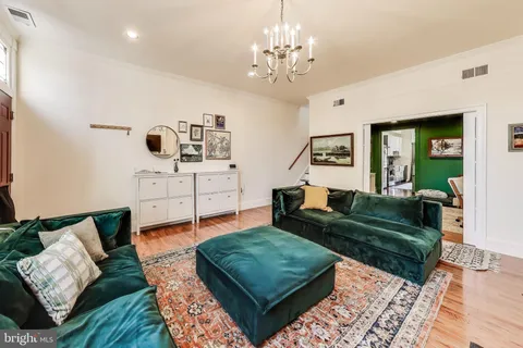 a living room with furniture and a chandelier