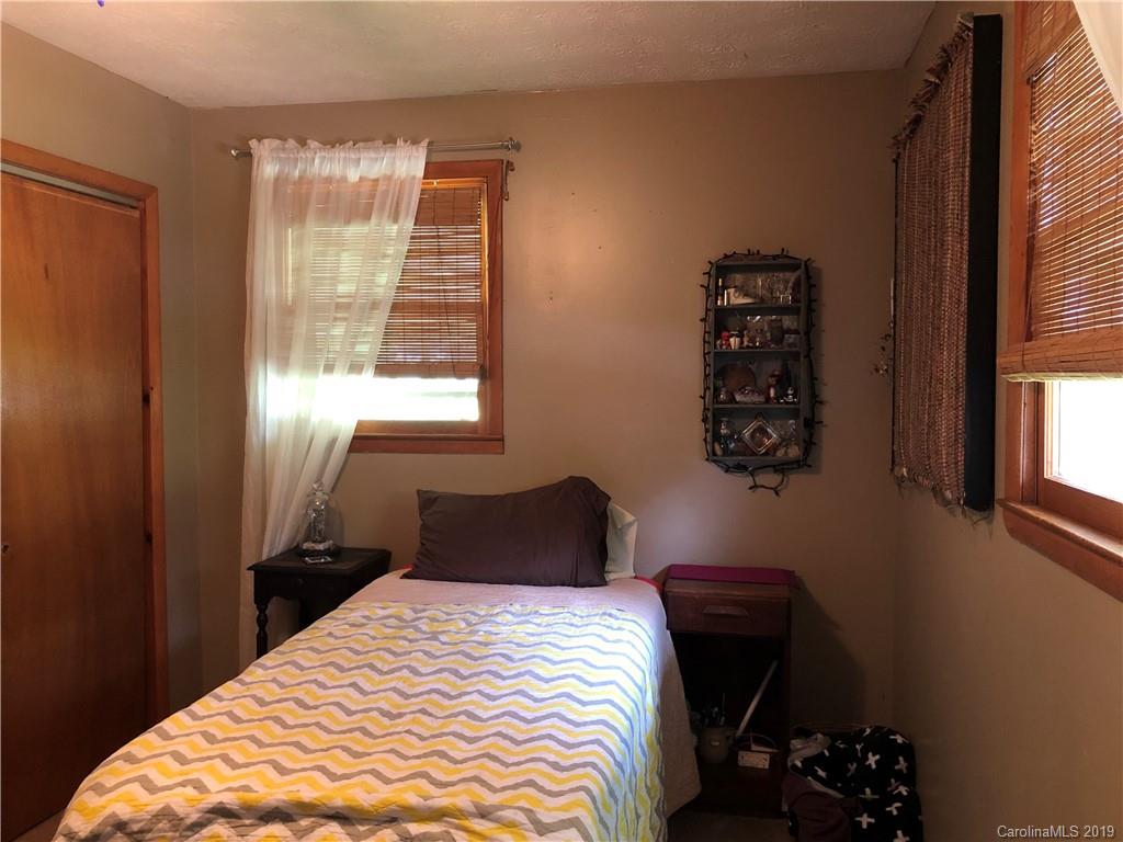 87 Cresent Loop Canton, NC 28716 - Photo 13 of 31 a bedroom with a bed and a window