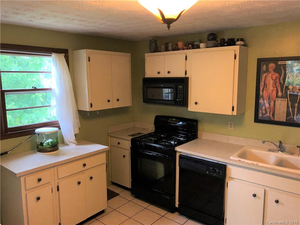 87 Cresent Loop Canton, NC 28716 - Photo 15 of 31 a kitchen with stainless steel appliances a stove a sink and a refrigerator