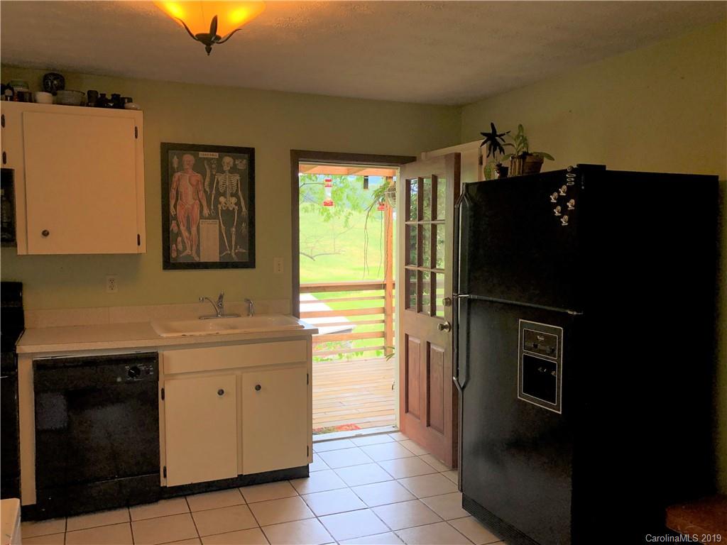87 Cresent Loop Canton, NC 28716 - Photo 16 of 31 a kitchen with a refrigerator and a stove