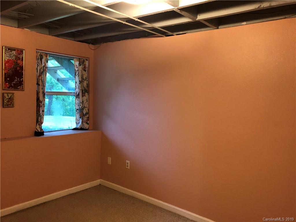 87 Cresent Loop Canton, NC 28716 - Photo 22 of 31 a small space with a window and a potted plant on the wall