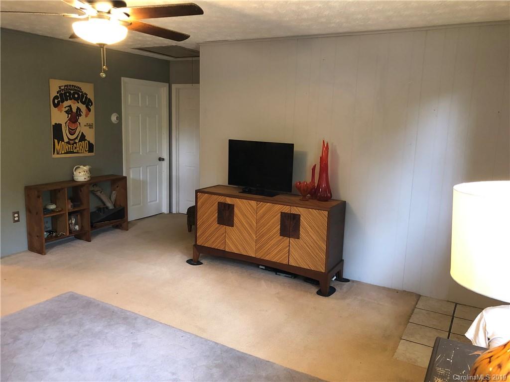 87 Cresent Loop Canton, NC 28716 - Photo 7 of 31 a bedroom with furniture and a flat screen tv