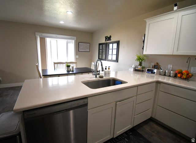 1688 West 200 North Mapleton, UT 84664 - Photo 3 of 18 Kitchen with dark wood-style floors, a peninsula, stainless steel dishwasher, white cabinetry, and healthy amount of natural light