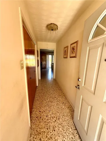 view of a hallway with wooden floor and a bathroom