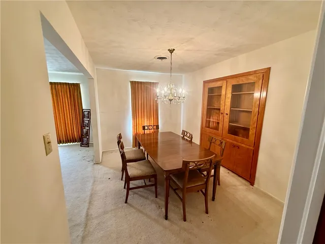 a view of a dining room with furniture and window
