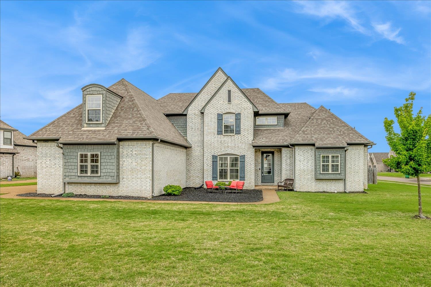 a front view of house with yard and green space