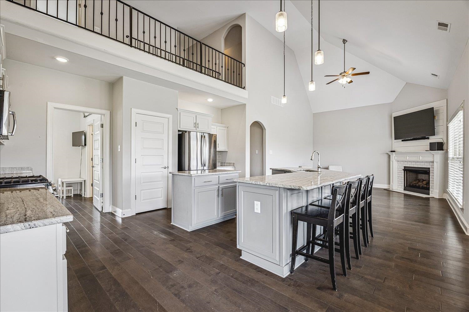 12802 Longmire Loop South Arlington, TN 38002 - Photo 11 of 40 a kitchen with kitchen island a dining table chairs stainless steel appliances and cabinets