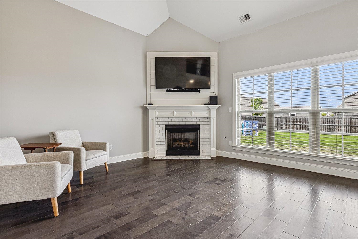 12802 Longmire Loop South Arlington, TN 38002 - Photo 15 of 40 a living room with furniture a flat screen tv and a fireplace