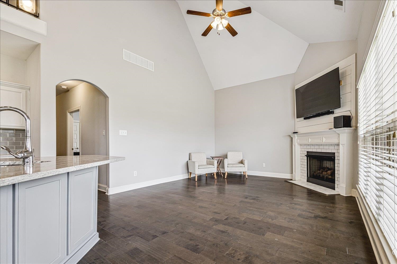 12802 Longmire Loop South Arlington, TN 38002 - Photo 16 of 40 a living room with furniture a fireplace and a flat screen tv