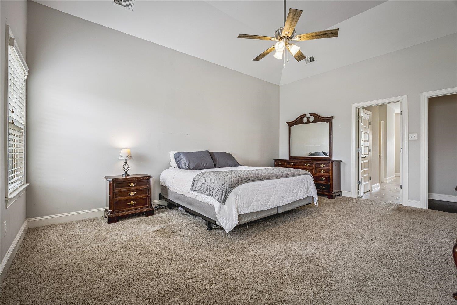 12802 Longmire Loop South Arlington, TN 38002 - Photo 18 of 40 a bedroom with a bed and a chandelier
