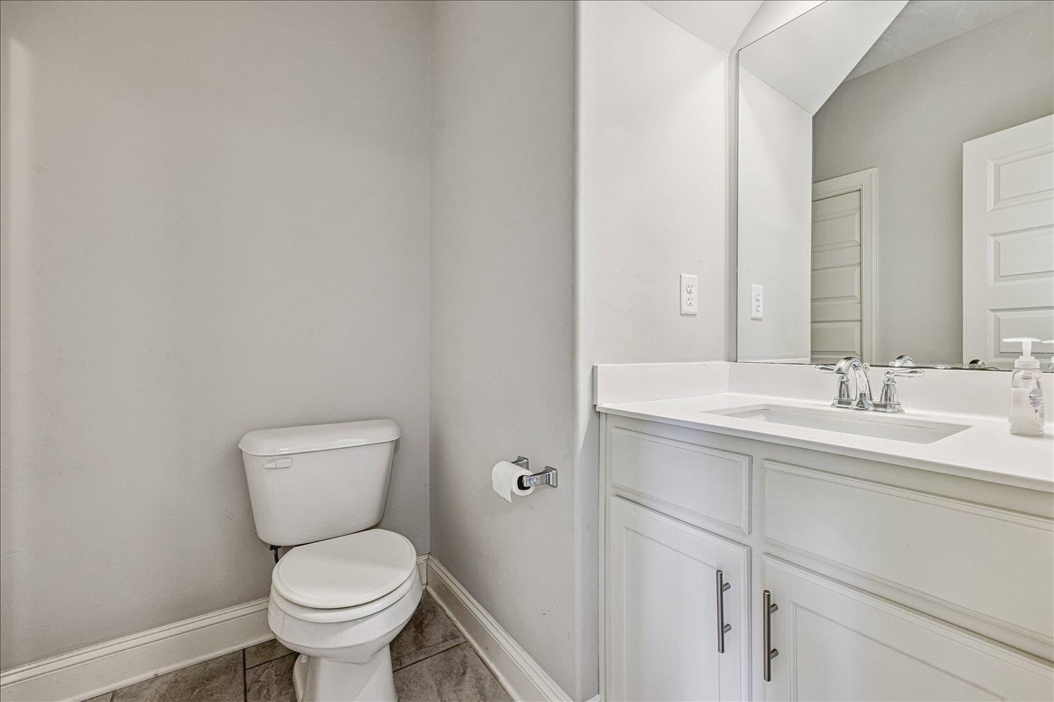 12802 Longmire Loop South Arlington, TN 38002 - Photo 24 of 40 a bathroom with a toilet sink vanity and mirror