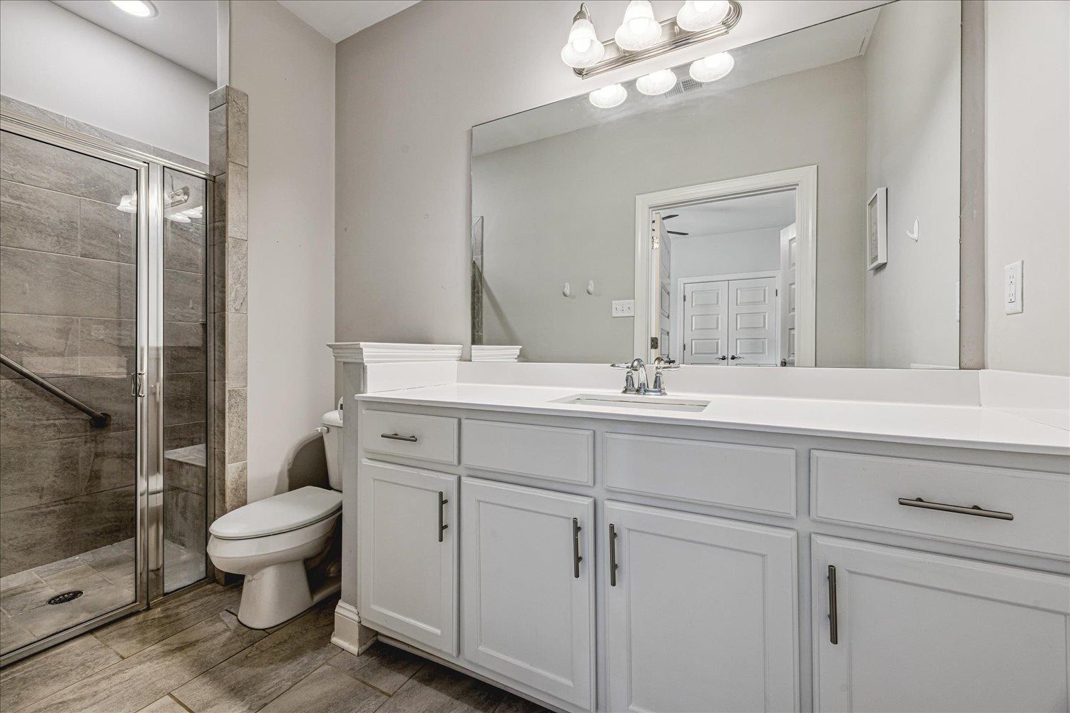 12802 Longmire Loop South Arlington, TN 38002 - Photo 26 of 40 a bathroom with a toilet sink and mirror