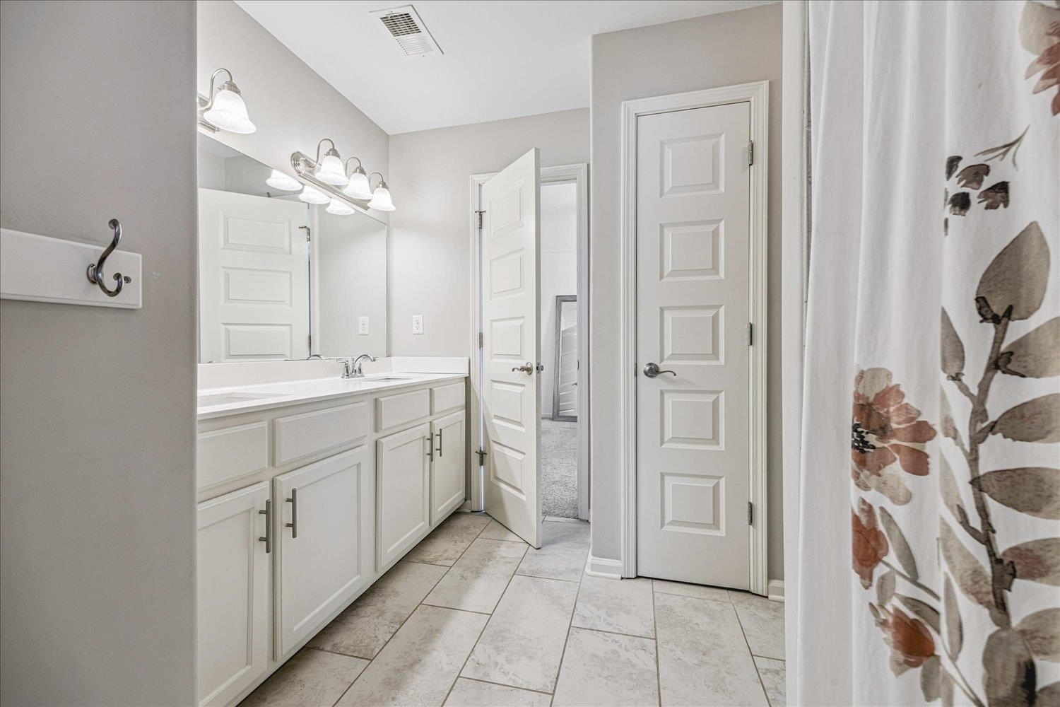 12802 Longmire Loop South Arlington, TN 38002 - Photo 31 of 40 a spacious bathroom with a double vanity sink a mirror and a shower
