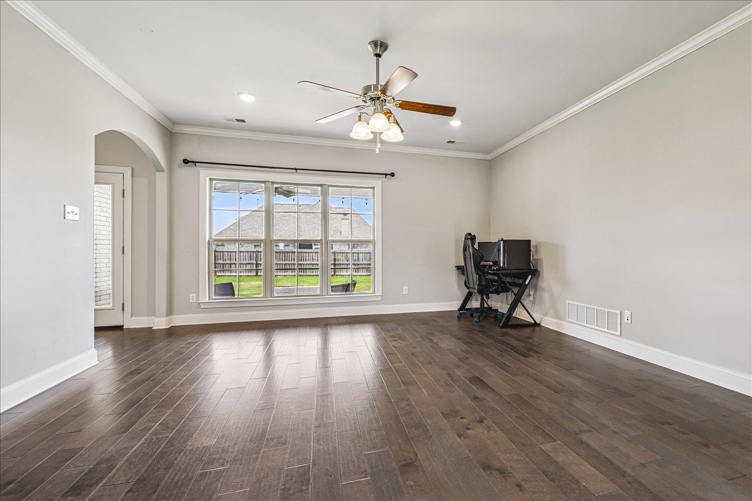 12802 Longmire Loop South Arlington, TN 38002 - Photo 6 of 40 an empty room with wooden floor fan and windows