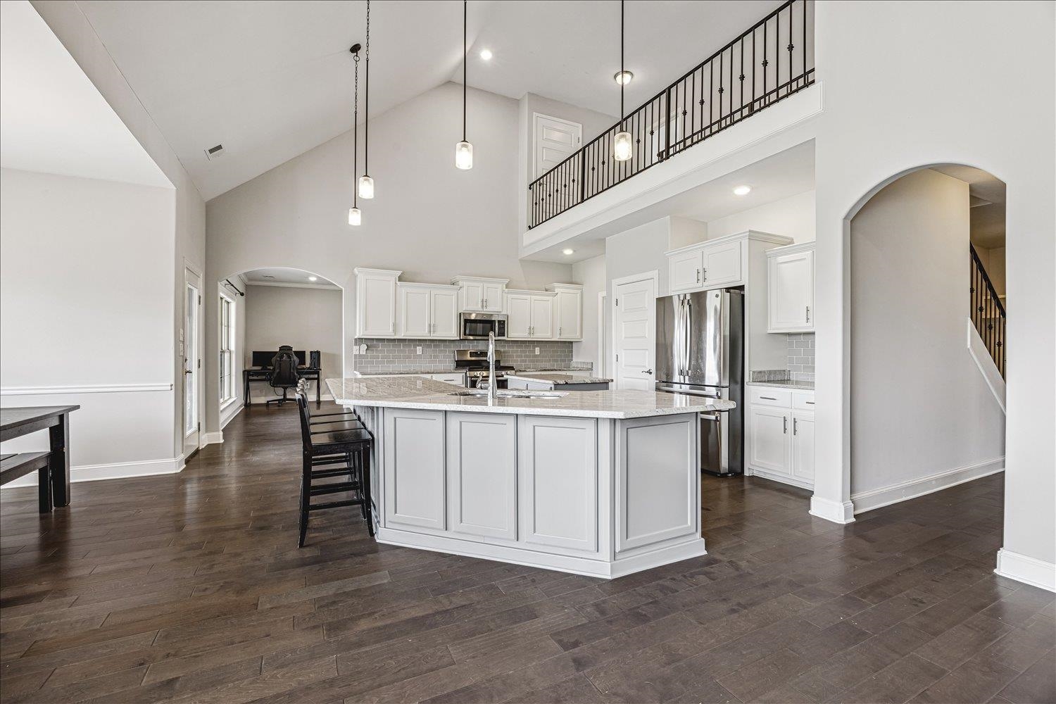12802 Longmire Loop South Arlington, TN 38002 - Photo 10 of 40 a kitchen with stainless steel appliances granite countertop a refrigerator a stove a sink dishwasher and white cabinets with wooden floor