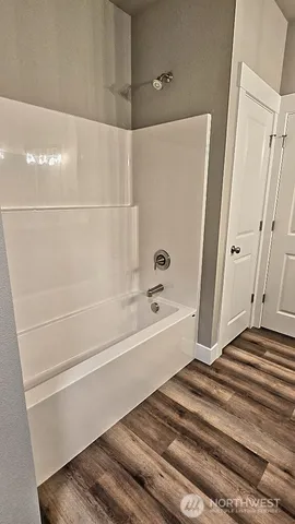 a bathroom with a bathtub and a shower