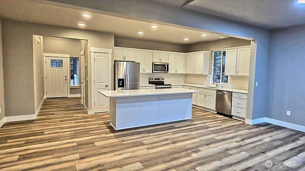573 Monte Elma Road Montesano, WA 98563 - Photo 3 of 13 a kitchen with stainless steel appliances kitchen island granite countertop a stove a sink and a refrigerator