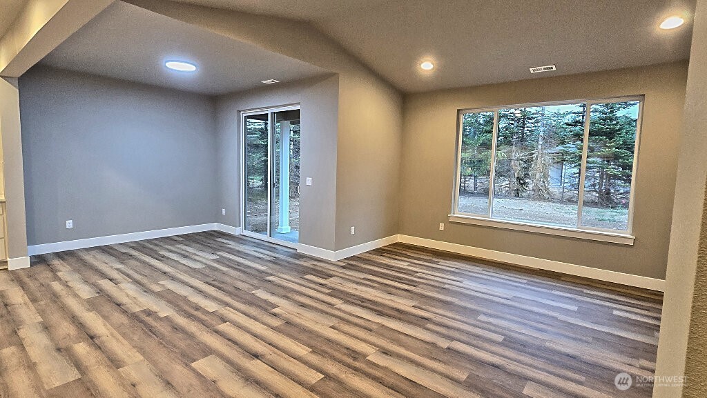 573 Monte Elma Road Montesano, WA 98563 - Photo 4 of 13 a view of an empty room with wooden floor and a window