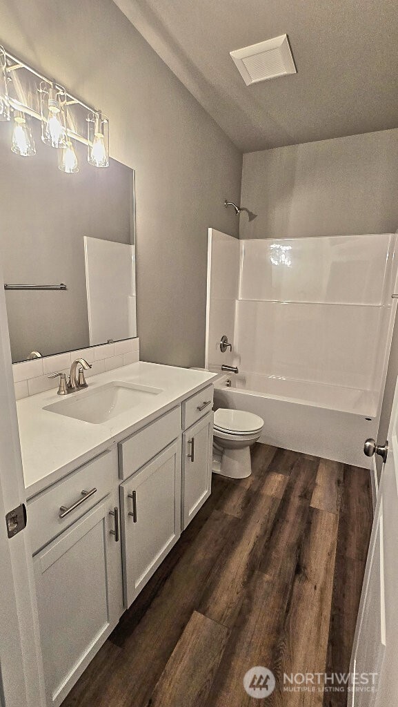 573 Monte Elma Road Montesano, WA 98563 - Photo 7 of 13 a bathroom with a double vanity sink toilet and mirror