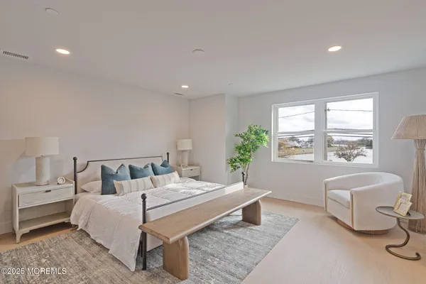 a spacious bedroom with a bed and a couch