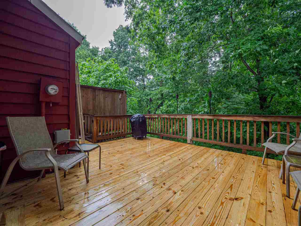 5406 Scenic View Lane Raleigh, NC 27612 - Photo 24 of 27 Wooded views from deck with stairs that lead to hot tub and ground level. Back Deck