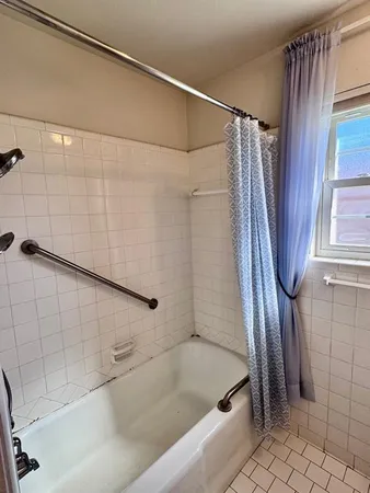 a bathroom with a shower and a tub