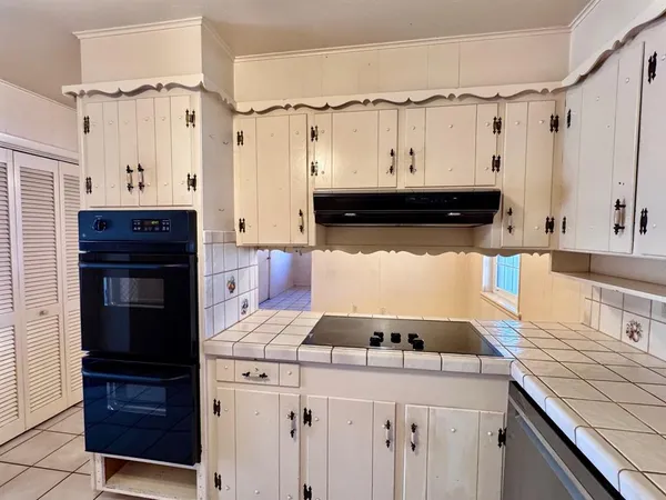a kitchen with a stove and a refrigerator
