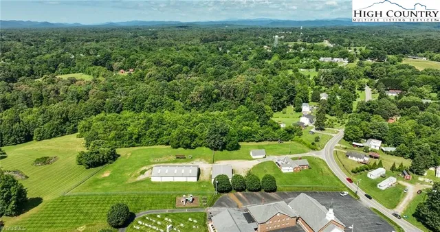 a kitchen with a table chairs a sink dishwasher window and cabinets