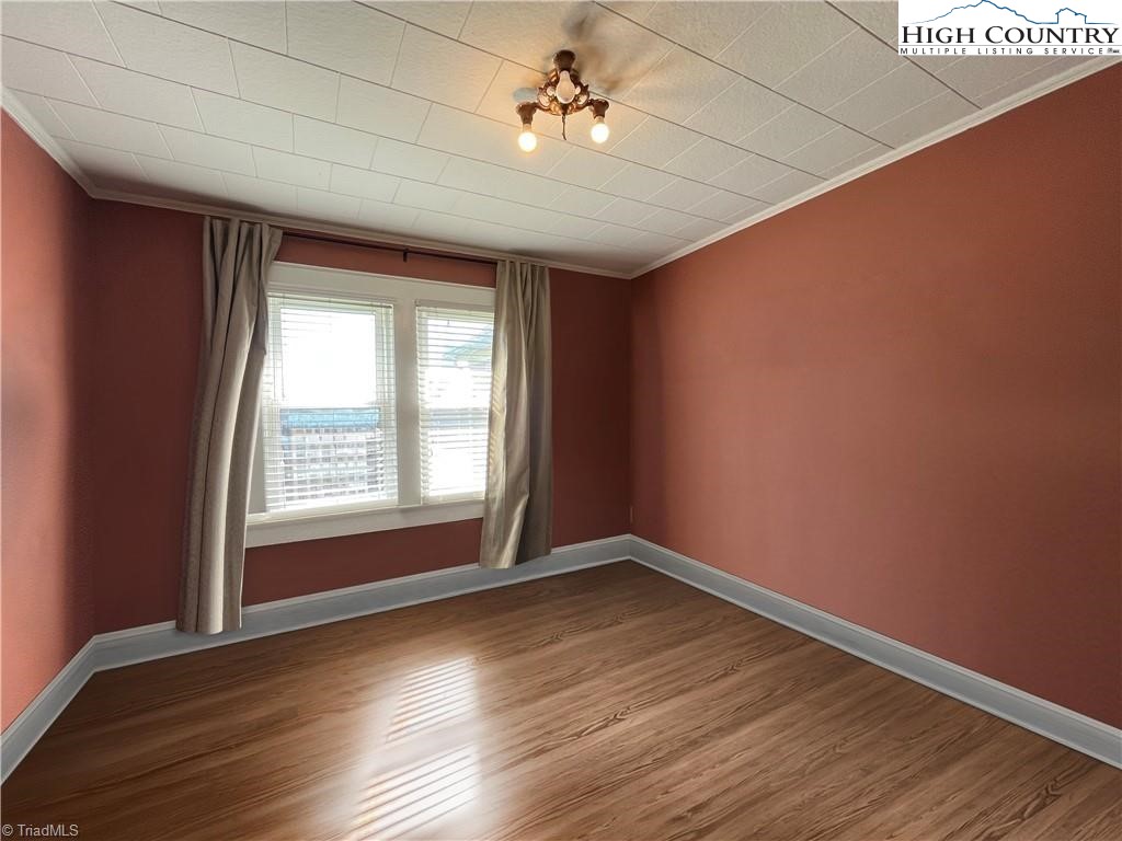 820 Suncrest Orchard Road North Wilkesboro, NC 28659 - Photo 26 of 41 an empty room with wooden floor and windows
