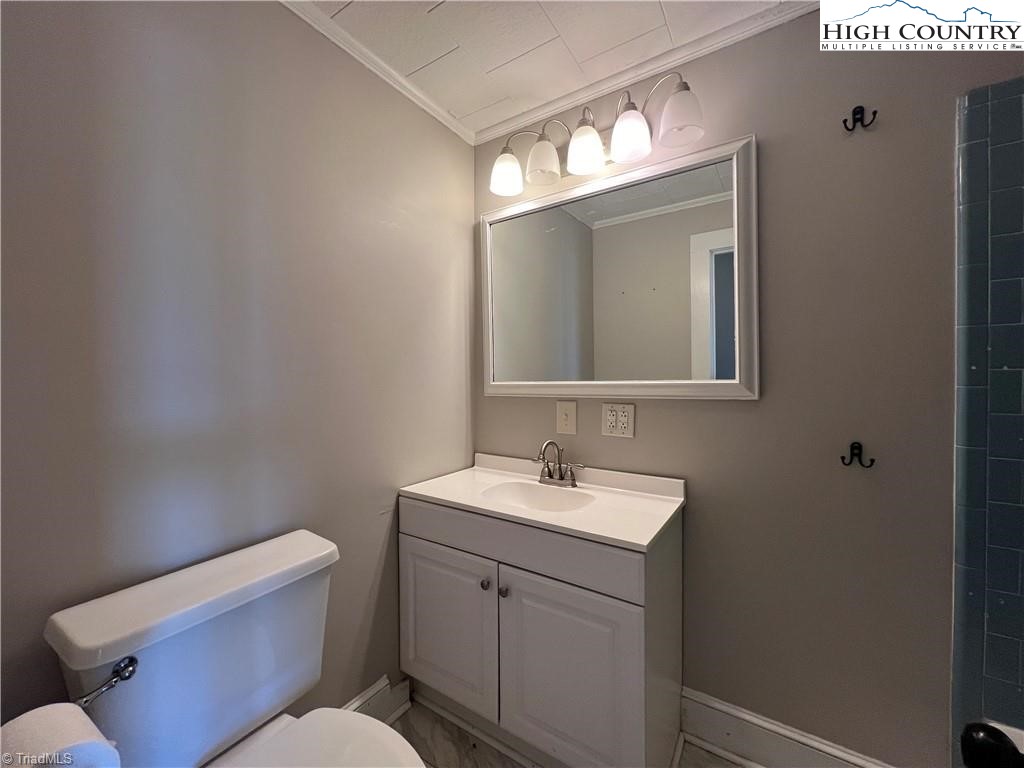 820 Suncrest Orchard Road North Wilkesboro, NC 28659 - Photo 38 of 41 a bathroom with a toilet sink and mirror