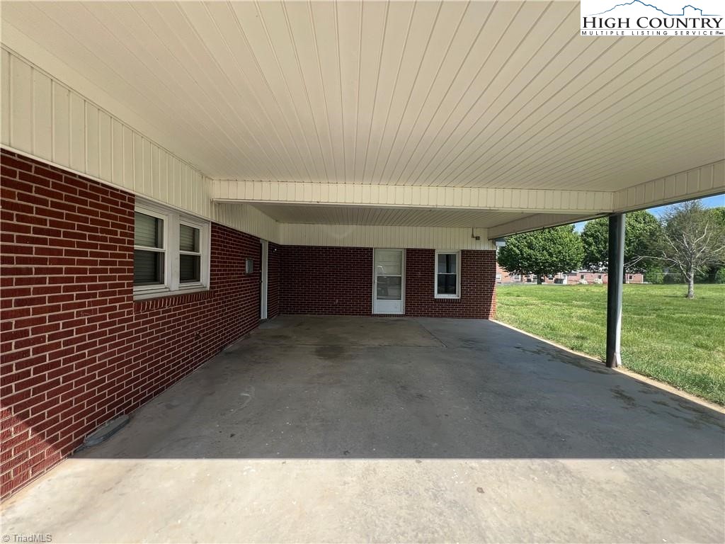 820 Suncrest Orchard Road North Wilkesboro, NC 28659 - Photo 41 of 41 a view of a house with floor to ceiling window and tree in front of it