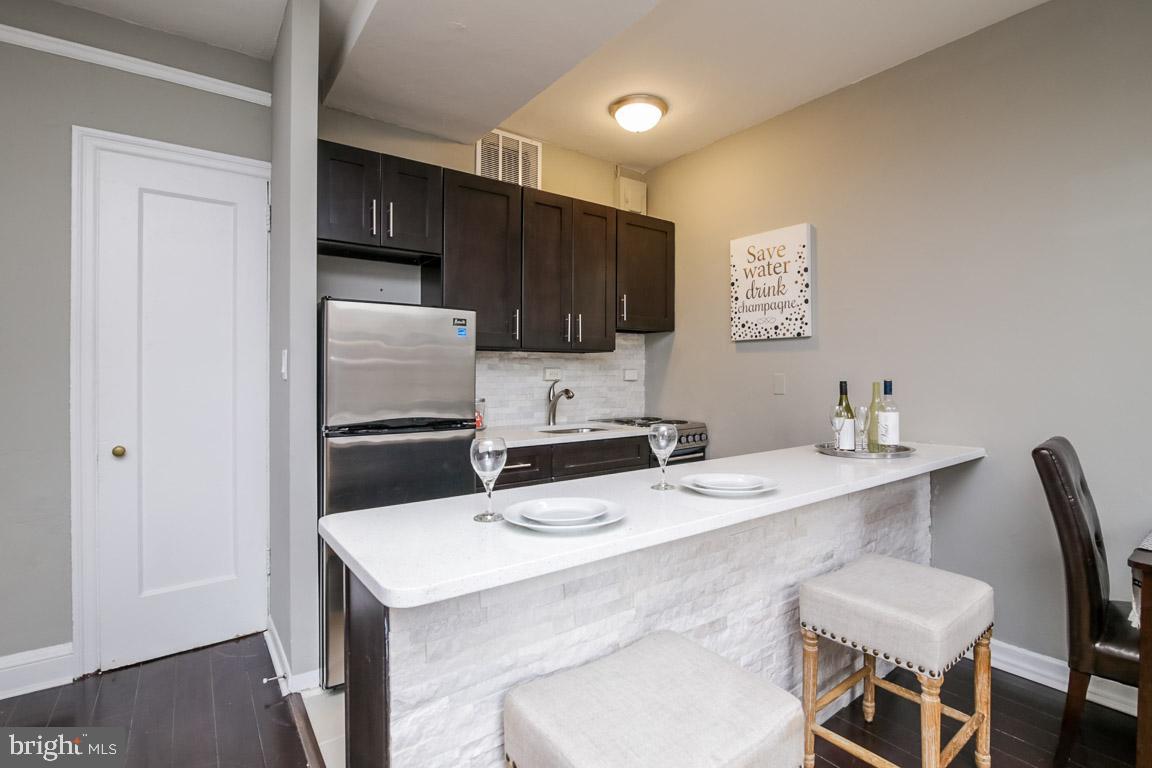 2031 Locust Street, Unit 203 Philadelphia, PA 19103 - Photo 4 of 17 a kitchen view with appliances a sink and cabinets