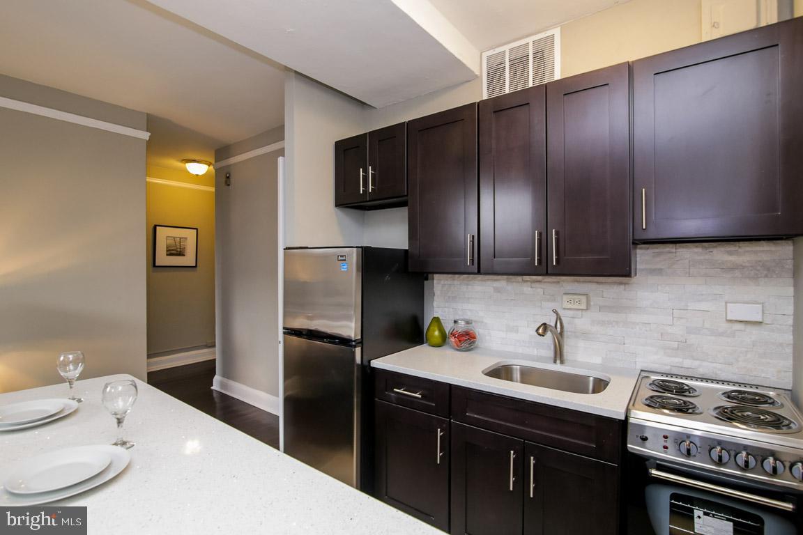 2031 Locust Street, Unit 203 Philadelphia, PA 19103 - Photo 5 of 17 a kitchen with a sink appliances and cabinets