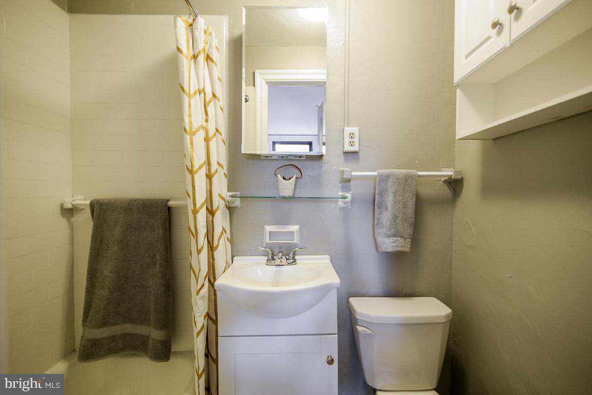 2031 Locust Street, Unit 203 Philadelphia, PA 19103 - Photo 8 of 17 a bathroom with a sink toilet and mirror