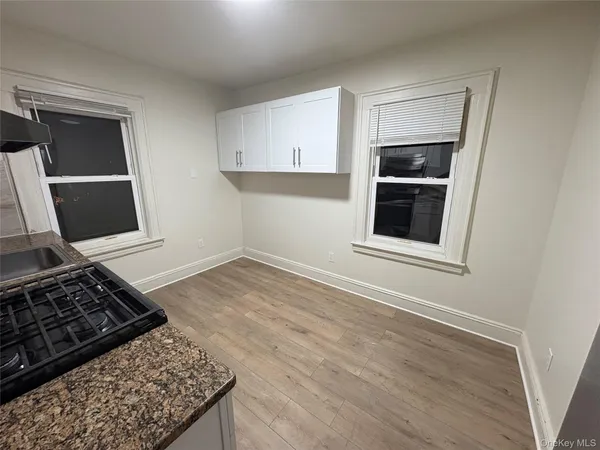 a kitchen with wooden floor and appliances