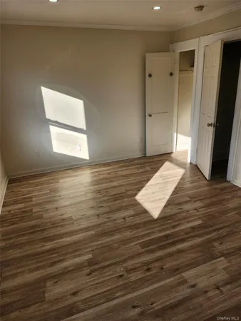 a view of an empty room and wooden floor
