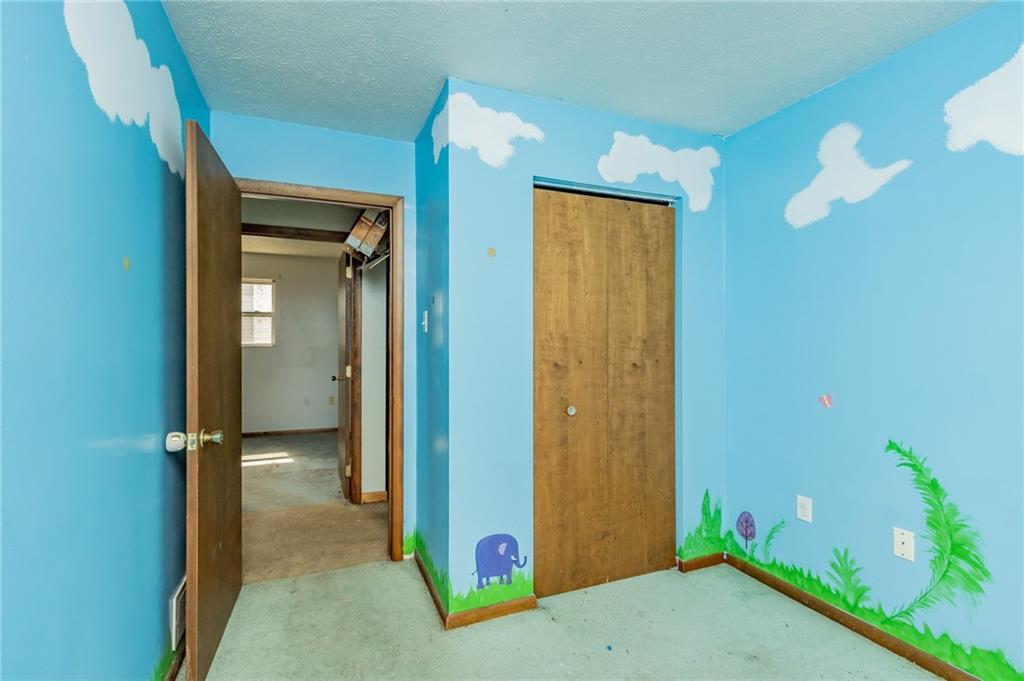 333 Butler Street Springdale, PA 15144 - Photo 13 of 17 a view of a bathroom with a shower and a mirror