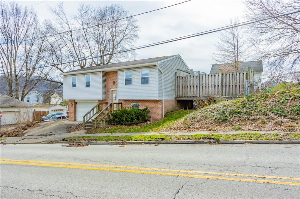 333 Butler Street Springdale, PA 15144 - Photo 2 of 17 a front view of a house with a yard and potted plants