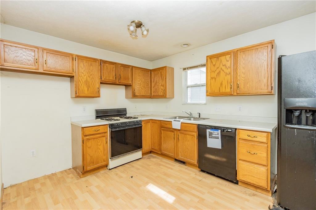 333 Butler Street Springdale, PA 15144 - Photo 9 of 17 a kitchen with stainless steel appliances granite countertop a sink stove and refrigerator