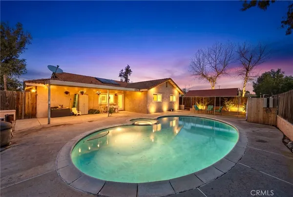 swimming pool view with a seating space