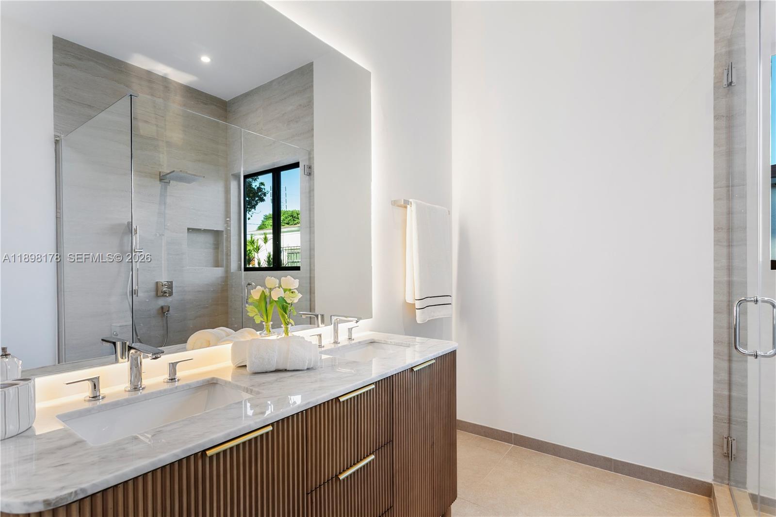 2434 Southwest 19th Street Miami, FL 33145 - Photo 11 of 18 a bathroom with a granite countertop sink a mirror and a shower