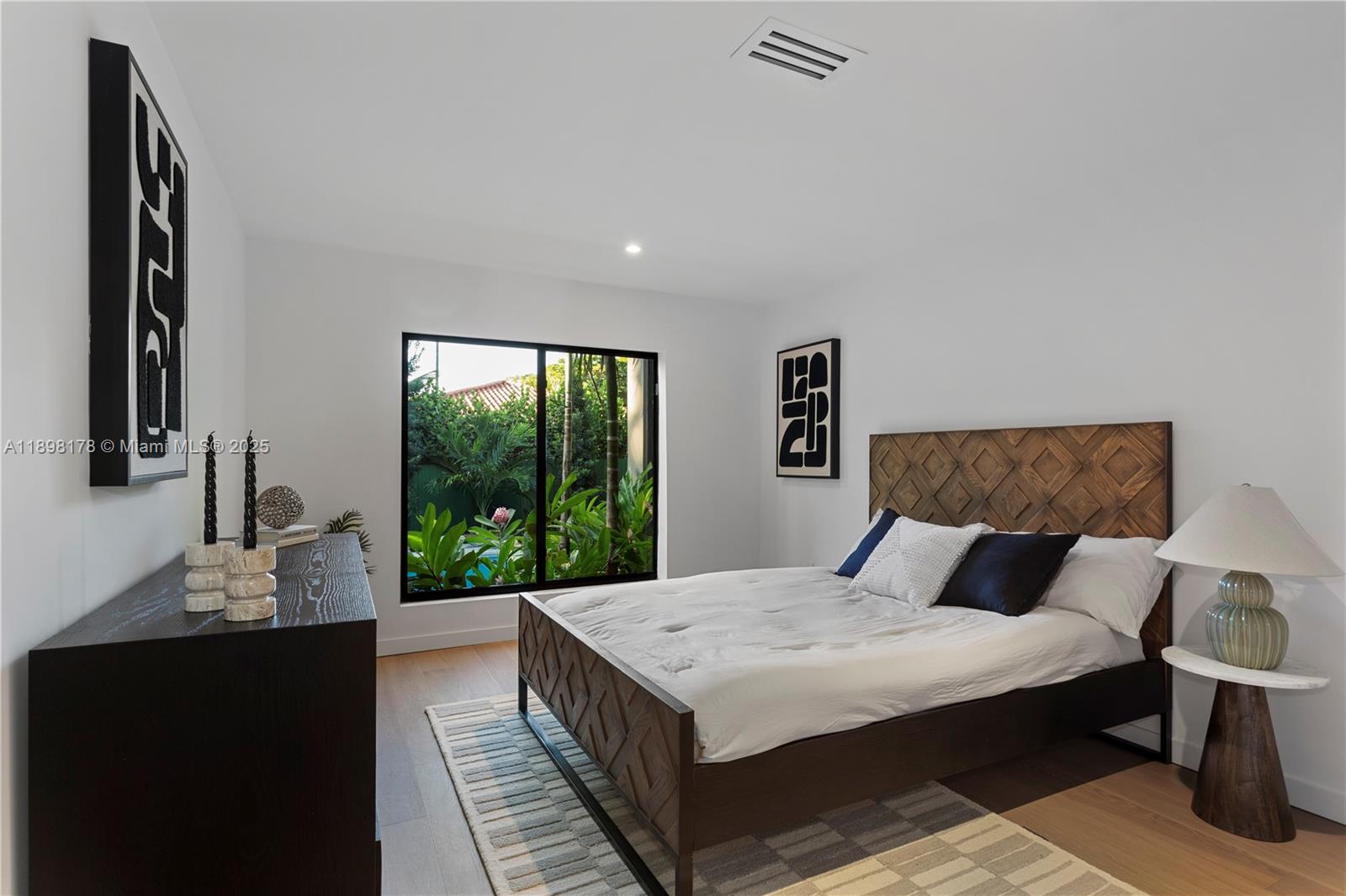 2434 Southwest 19th Street Miami, FL 33145 - Photo 14 of 18 a bedroom with a large bed and a window