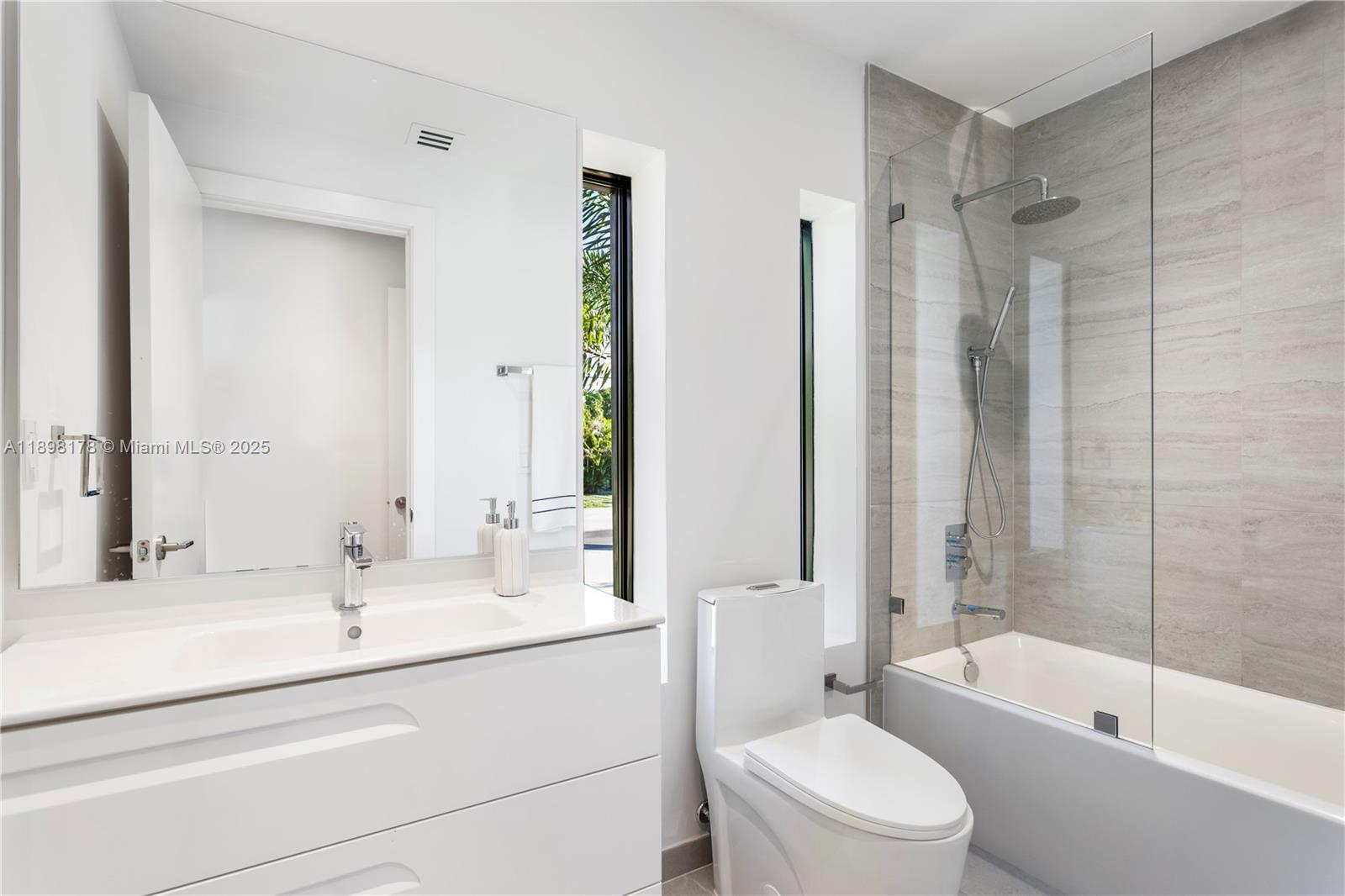 2434 Southwest 19th Street Miami, FL 33145 - Photo 15 of 18 a bathroom with a sink a toilet and shower