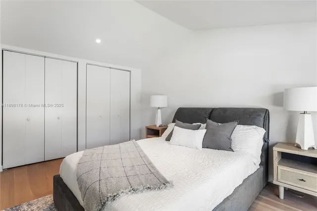 a bedroom with a bed and a night stand