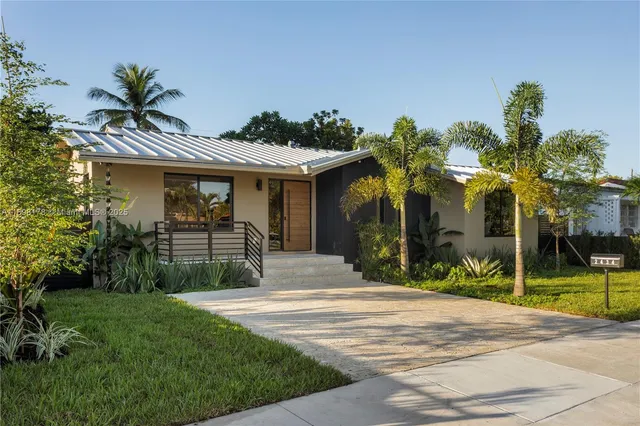 a front view of a house with a garden